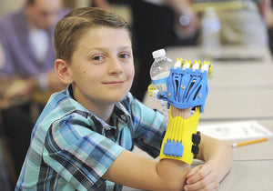Fourth graders at Roy B. Kelley Elementary design and produce a prosthetic hand for their classmate